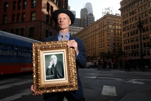Richard Sharon holds a portrait of President Warren Harding outside the Palace Hotel, the San Francisco landmark once owned by his family. Harding died there in 1923. (Karl Mondon/Bay Area News Group)