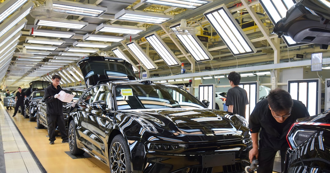 Workers inspect Zeekr 001 electric cars at the automaker’s factory in Ningbo, China. Zeekr engineers in China pass work at the end of each day to colleagues at its design center in Sweden, enabling up to 20 uninterrupted hours of development. REUTERS/Nick Carey