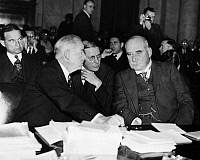 0114621 Granger - Historical Picture ArchiveSENATE MUNITIONS HEARINGS. <br />Left to right: American financiers Thomas Lamont, George Whitney and John Pierpont Morgan, Jr., in a huddle before a session of hearings by the Senate Munitions Committe, 1936.