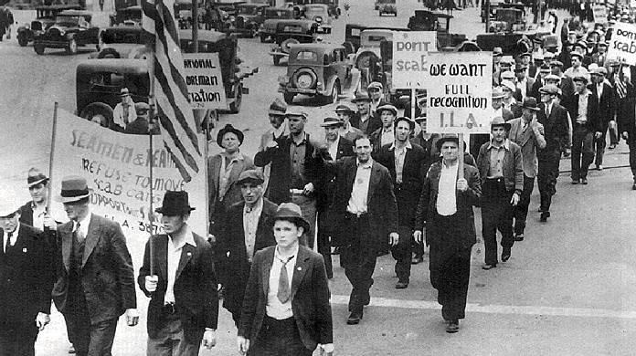 A group of men marching in a street

AI-generated content may be incorrect.