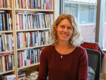 A person smiling in front of a bookcase

AI-generated content may be incorrect.