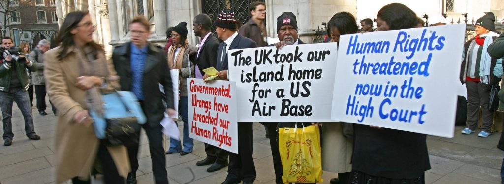 Chagossian Islanders and their supporters arrive at the Court of Appeal in central London, Feb. 5, 2007, some holding protest signs, as they prepared to fight a court ruling that would prevent the islanders going back to their homes in the remote Chagos archipelago, in the middle of the Indian Ocean. The islanders had already won two legal cases in the UK courts - in 2000 and 2006 - that ruled their expulsion was illegal. Their removal began in the 1960s, after the US and UK reached a secret deal to turn the island of Diego Garcia into a US military base, without local inhabitants. (Photo byCARL DE SOUZA/AFP via Getty Images)