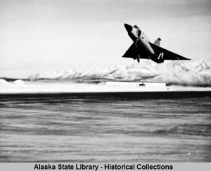 Fighter jet on takeoff at Elmendorf Air Force Base, Anchorage, Alaska. ASL-P553-03, Oliver Middaugh Photograph Collection, Alaska State Library-Historical Collections.