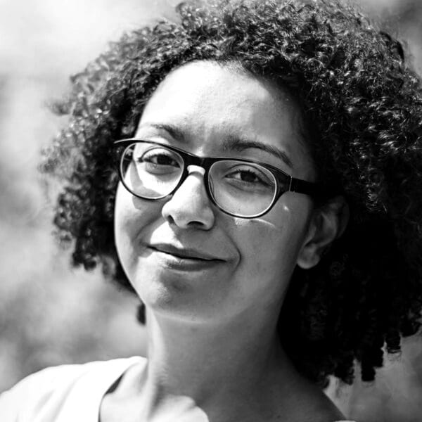 A person with curly hair wearing glasses

AI-generated content may be incorrect.