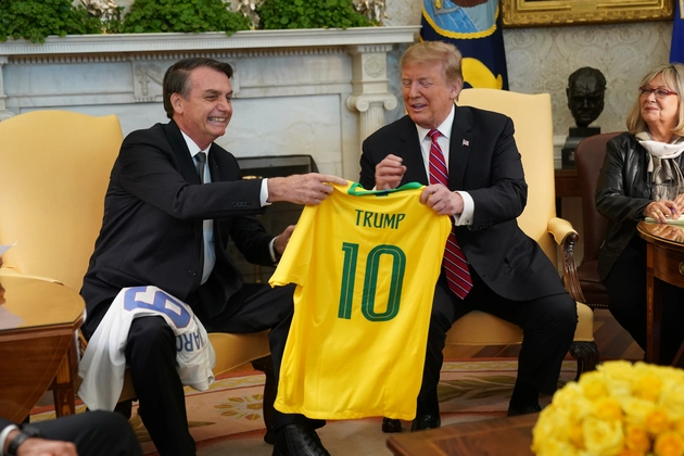 Brazilian President Jair Bolsonaro presents President Donald Trump with a Brazil national soccer team jersey