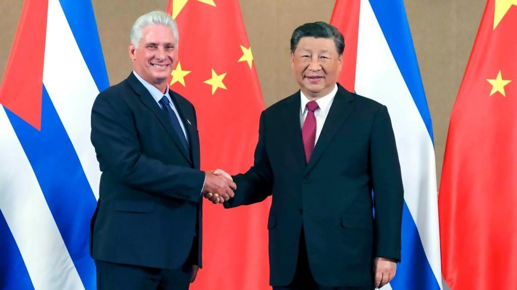 Men in suits shaking hands with flags

AI-generated content may be incorrect.