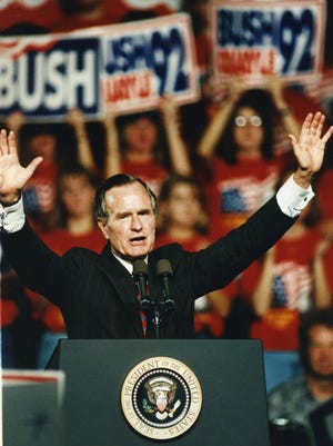 President George Bush waves from the podium at Austin Peay State University on his Tennessee campaign stop in Clarksville Sept. 29, 1992.